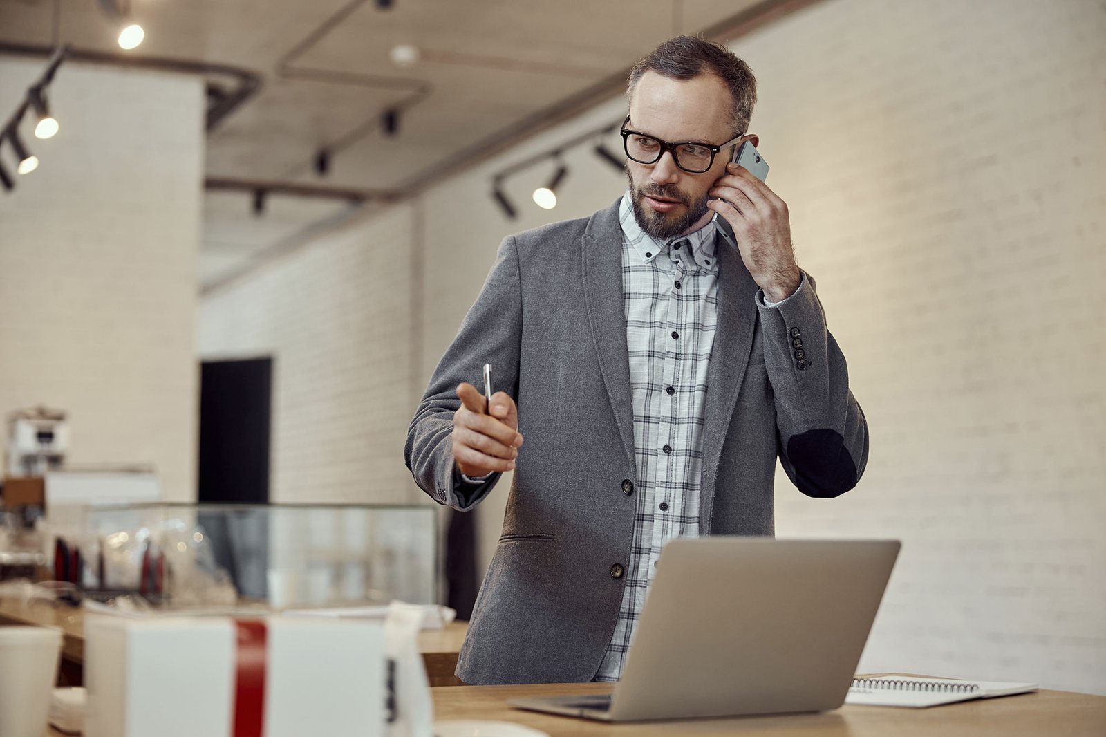 businessman talking on cellphone and using laptop 2023 11 27 05 19 19 utc